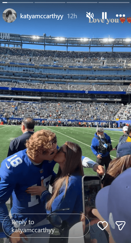 J.J. McCarthy and Katya McCarthy share a kiss before the Giants-Saints game on Sunday. 