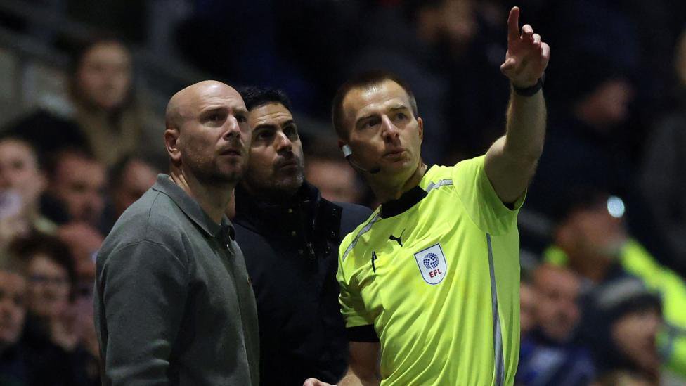 Referee Michael Salisbury spoke to both sides as play was halted