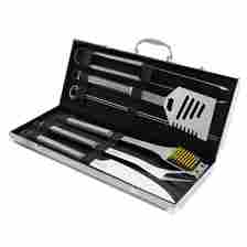 Barbecue grill tool set in an open metal case, featuring a spatula, tongs, fork, skewers, and a grill brush