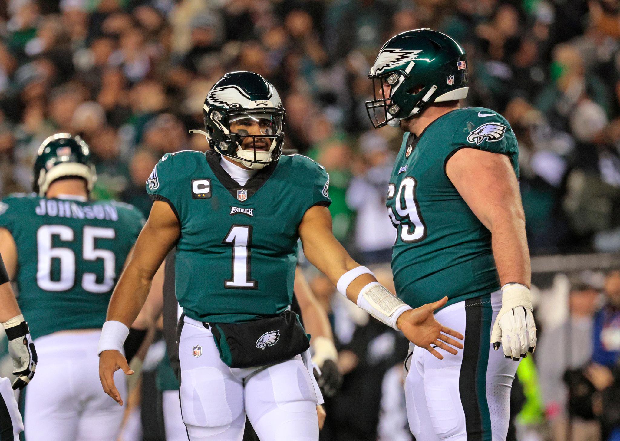 Philadelphia Eagles quarterback Jalen Hurts is greeted by center Landon Dickerson after throwing a touchdown pass.