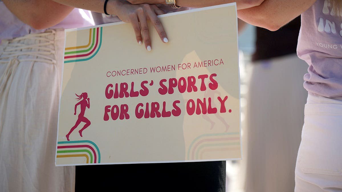 Supporters of female sports categories stand outside the U.S. Supreme Court building in Washington, D.C.
