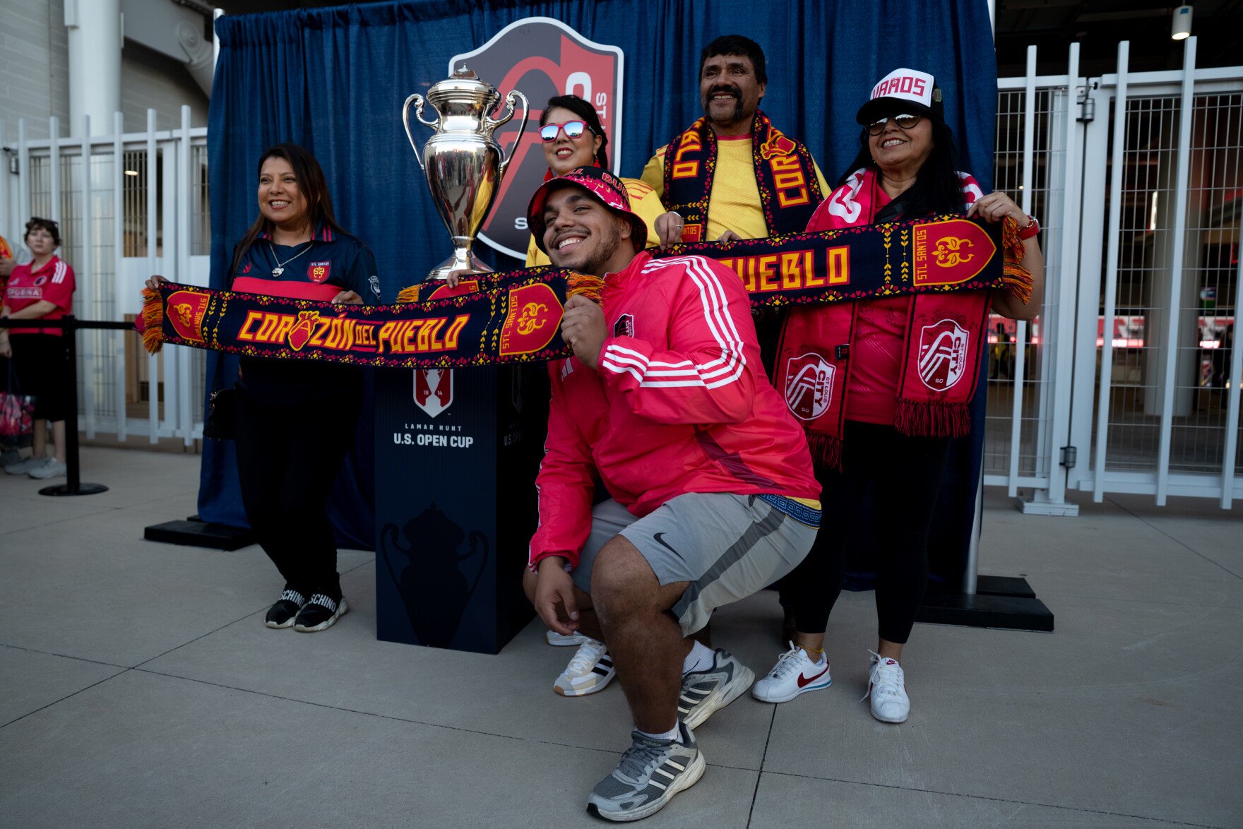 Randall Morales, of St. Charles, front, poses alongside fellow members of STL Santos, with the Lamar Hunt U.S. Open Cup trophy outside of Energizer Park on Wednesday, Oct. 28, 2026, in St. Louis’ Downtown West neighborhood.