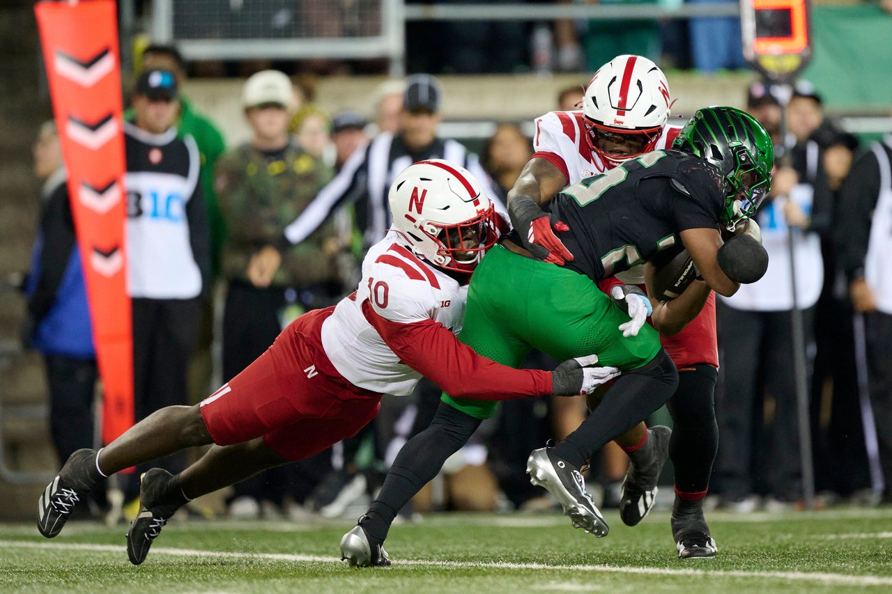 Oct 17, 2026; Eugene, Oregon, USA; Nebraska Cornhuskers linebacker Vincent Shavers Jr. (10) and defensive lineman Jahsear Whittington (1) tackle Oregon Ducks running back Brandon Smith (26)  during the first half at Autzen Stadium. Mandatory Credit: Troy Wayrynen-Imagn Images