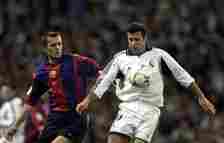 Lusi Figo of Real Madrid holds off Philip Cocu of Barcelona during the Real Madrid v FC Barcelona La Liga match played at the Santiago Bernabeau, M...