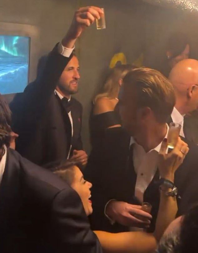 Kane raised his shot glass of champagne to the friends and family celebrating his Ballon d'Or win in Cirque le Soir in Soho on Monday night as the afterparty took off