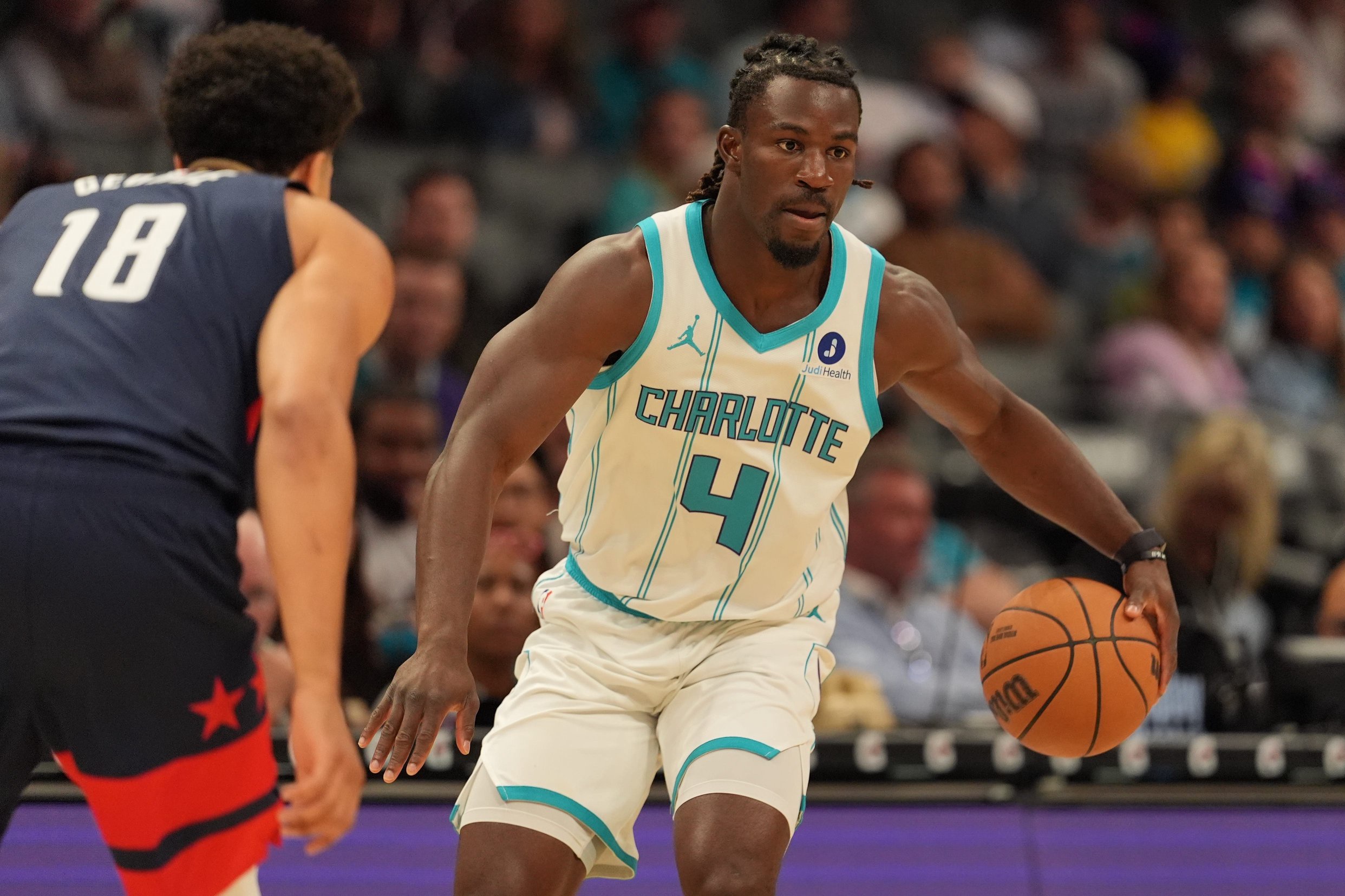 Oct 26, 2026; Charlotte, North Carolina, USA;  Charlotte Hornets guard Sion James (4) handles the ball against Washington Wizards forward Kyshawn George (18) during the first half at the Spectrum Center.  Mandatory Credit: Jim Dedmon-Imagn Images
