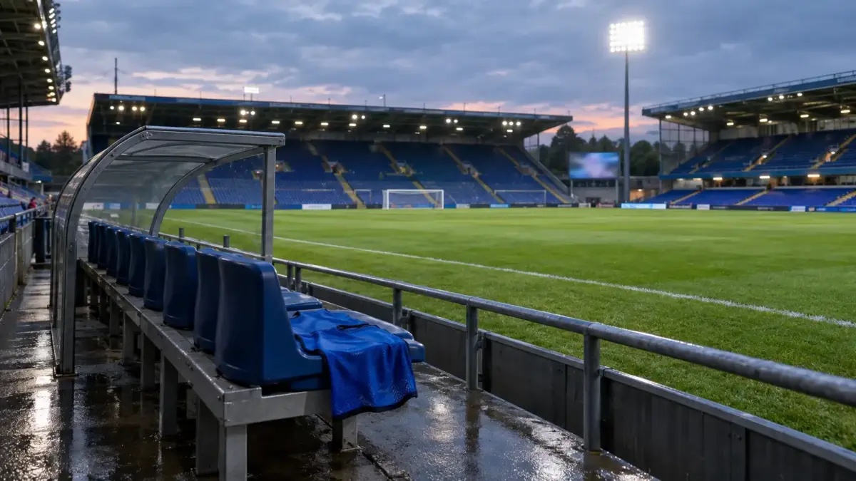 Empty football stadium training pitch with a blue bib on an unoccupied substitute bench
