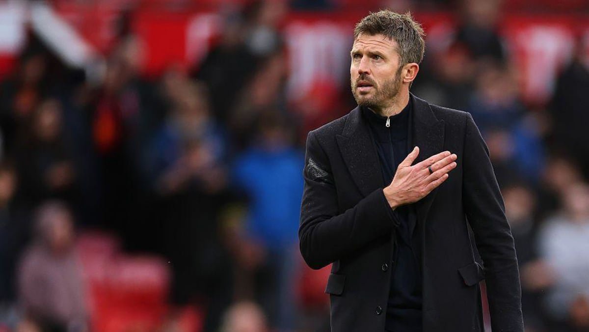 Manchester United boss Michael Carrick pats his heart