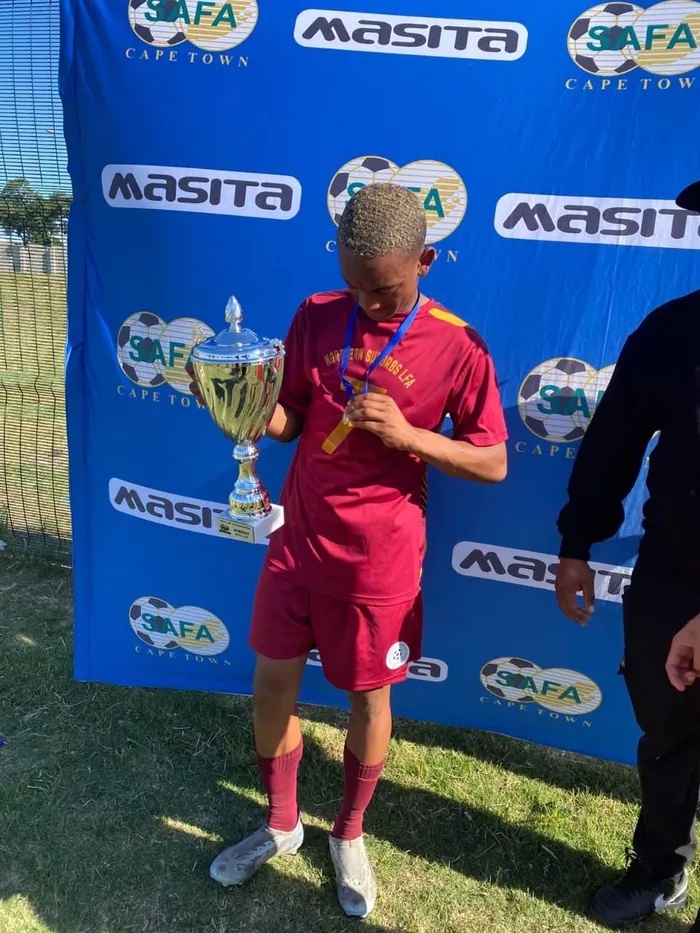 Sidney Schoeman with a trophy and medal from the Northern Suburbs LFA.