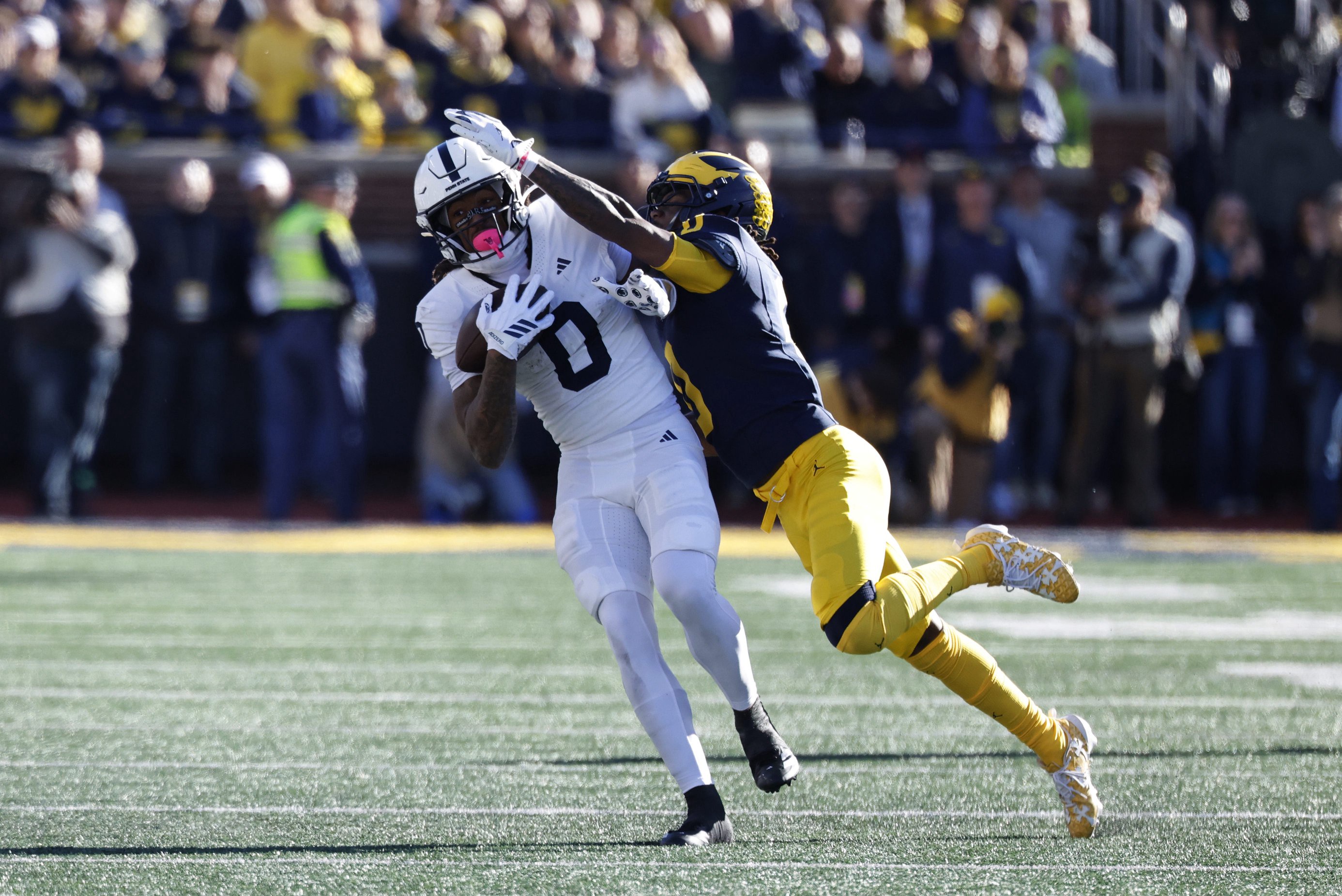 Oct 17, 2026; Ann Arbor, Michigan, USA;  Penn State Nittany Lions wide receiver Chase Sowell (0) makes a catch defended by by Michigan Wolverines defensive back Jyaire Hill (0) in the first half at Michigan Stadium.  Mandatory Credit: Rick Osentoski-Imagn Images