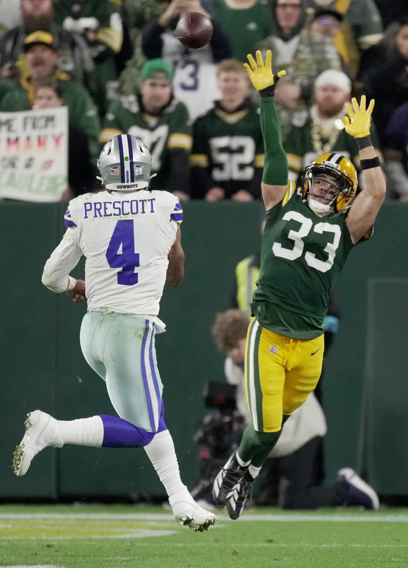 Green Bay Packers safety Evan Williams (33) tries to block a pass by Dallas Cowboys quarterback Dak Prescott (4) during the fourth quarter of their game Sunday, Oct. 18, 2026 at Lambeau Field in Green Bay, Wisconsin.