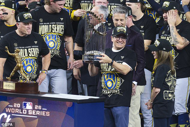 Milwaukee Brewers Owner Mark Attanasio holds the Commissioner's Trophy