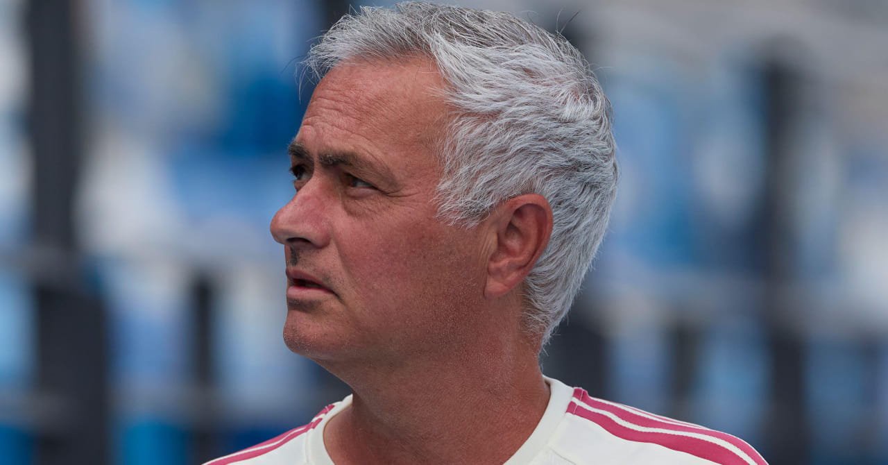 Football manager Jose Mourinho looking to his right while wearing a white shirt with light red trim in his role as head coach of La Liga football club Real Madrid