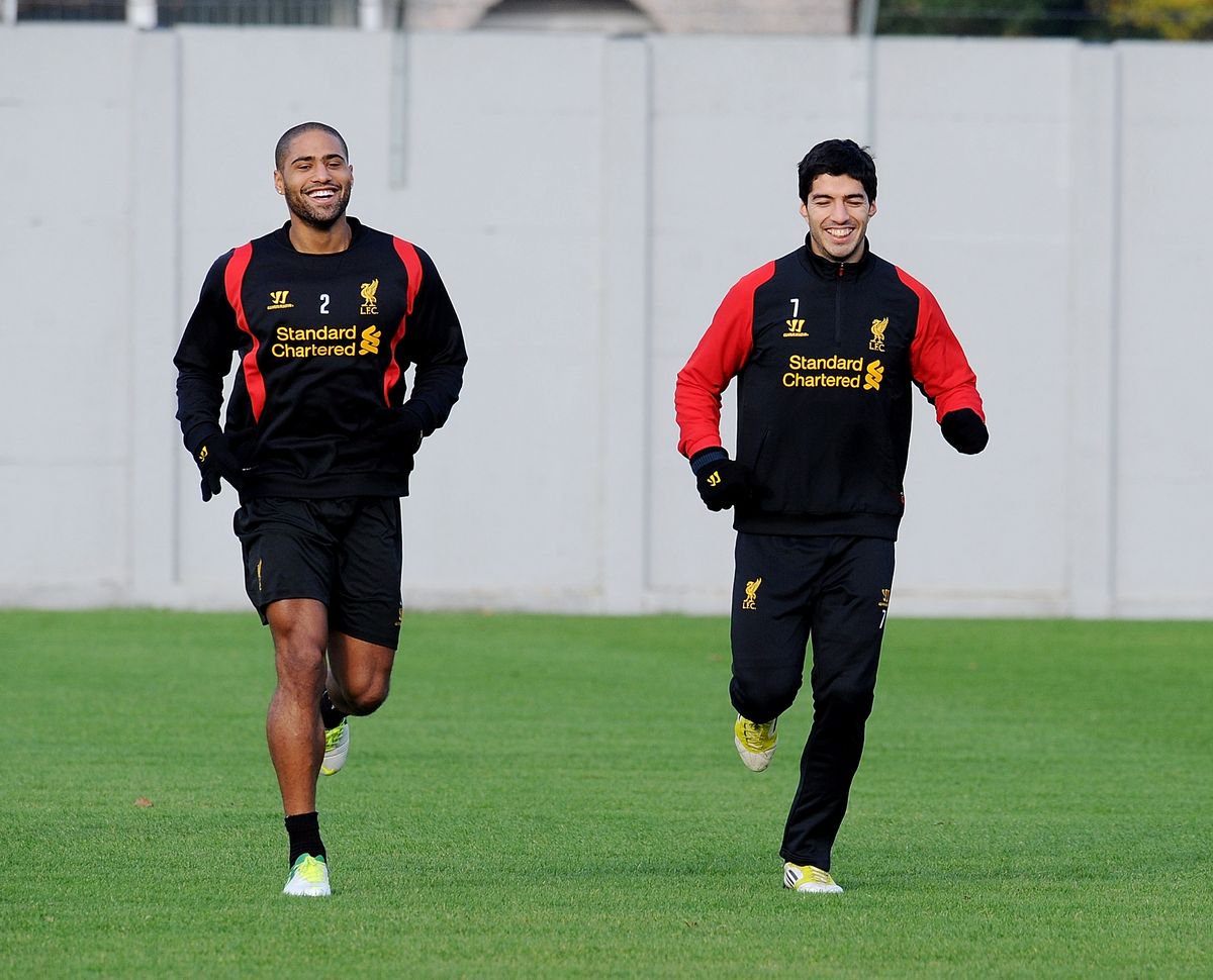 Glen Johnson and Luis Suarez of Liverpool in action during a training session at Melwood Training Ground