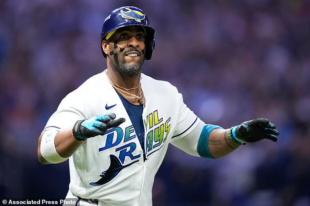 Tampa Bay Rays' Yandy Díaz celebrates his two-run home run against the Cleveland Guardians during the eighth inning in Game 6 of an American League Championship Series baseball game in St. Petersburg, Fla. Monday, Oct. 19, 2026. (AP Photo/David J. Phillip)