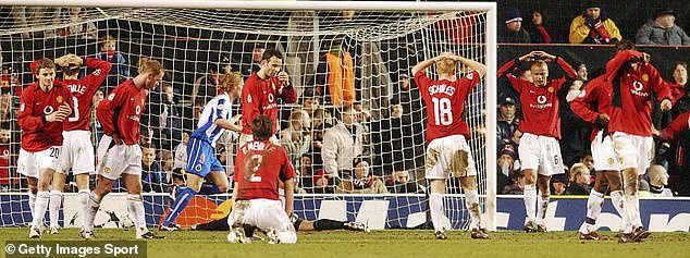 United players react in disbelief after Costinha (not pictured) equalised for Porto in the 90th minute