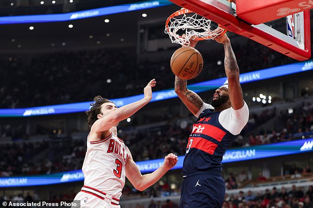 Washington Wizards forward Anthony Davis, left, dunks against Chicago Bulls guard Josh Giddey (3) during the first quarter of an NBA basketball game, Saturday, Oct. 24, 2026, in Chicago. (AP Photo/Jessie Alcheh)