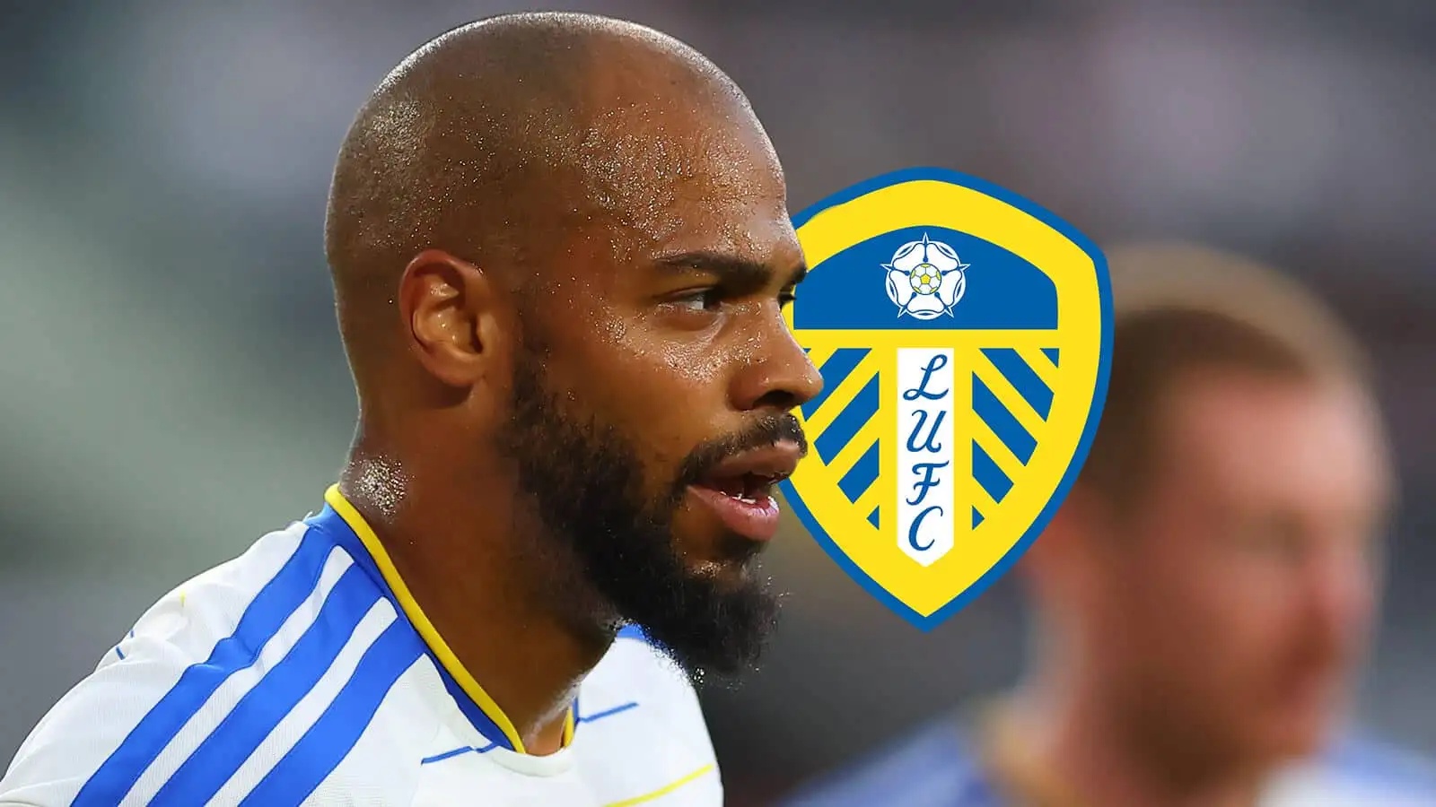 Leeds striker Lukas Nmecha next to the club badge
