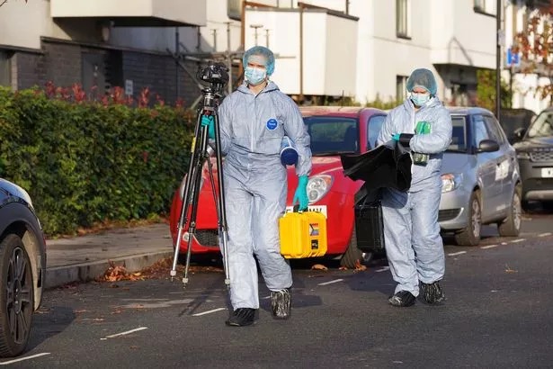 Forensic officers pictured at the scene of the shooting