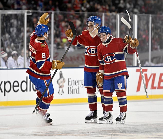 Montreal Canadiens' Kaiden Guhle, center, celebrates after his goal against the Winnipeg Jets with Mike Matheson (8) and Cole Caufield (13) during the second period of the NHL Heritage Classic hockey game in Winnipeg, Manitoba, Sunday, Oct. 25, 2026. (Fred Greenslade/The Canadian Press via AP)