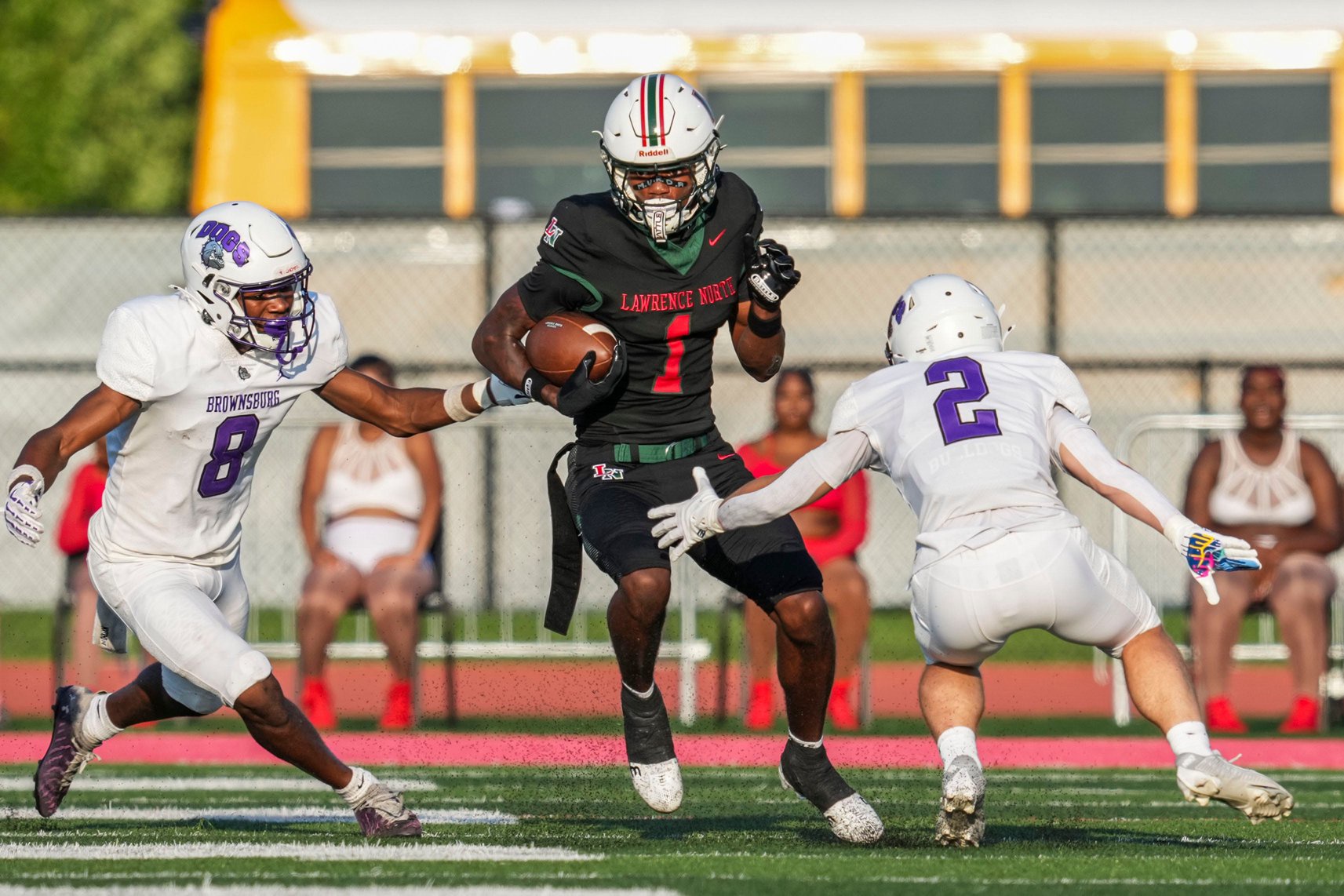 Brownsburg Bulldogs Trentin Russ (8) and Brownsburg Bulldogs Tye Morgan (2) guard Lawrence North Wildcats Monshun Sales (1) on Friday, Aug. 21, 2026, during a game at Lawrence North High School in Indianapolis.
