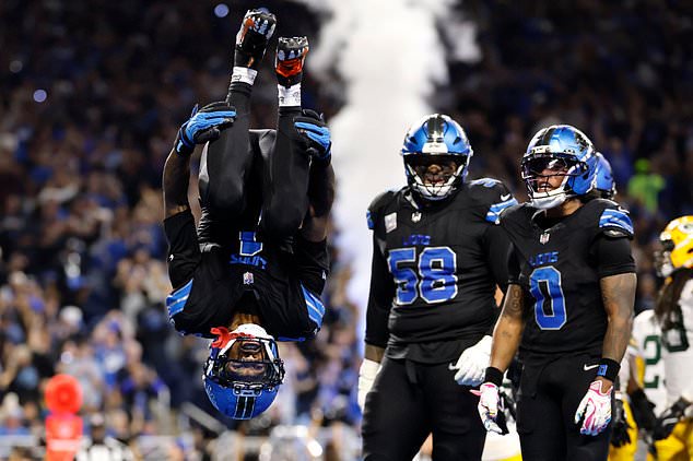 Detroit Lions wide receiver Jameson Williams (1) does a flip after catching a touchdown pass during the second half of an NFL football game against the Green Bay Packers, Sunday, Oct. 25, 2026, in Detroit. (AP Photo/Rey Del Rio)