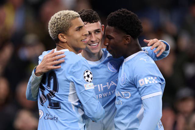 Phil Foden celebrates with Rico Lewis and Ryan McAidoo