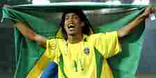 Ronaldinho holds the Brazil flag.