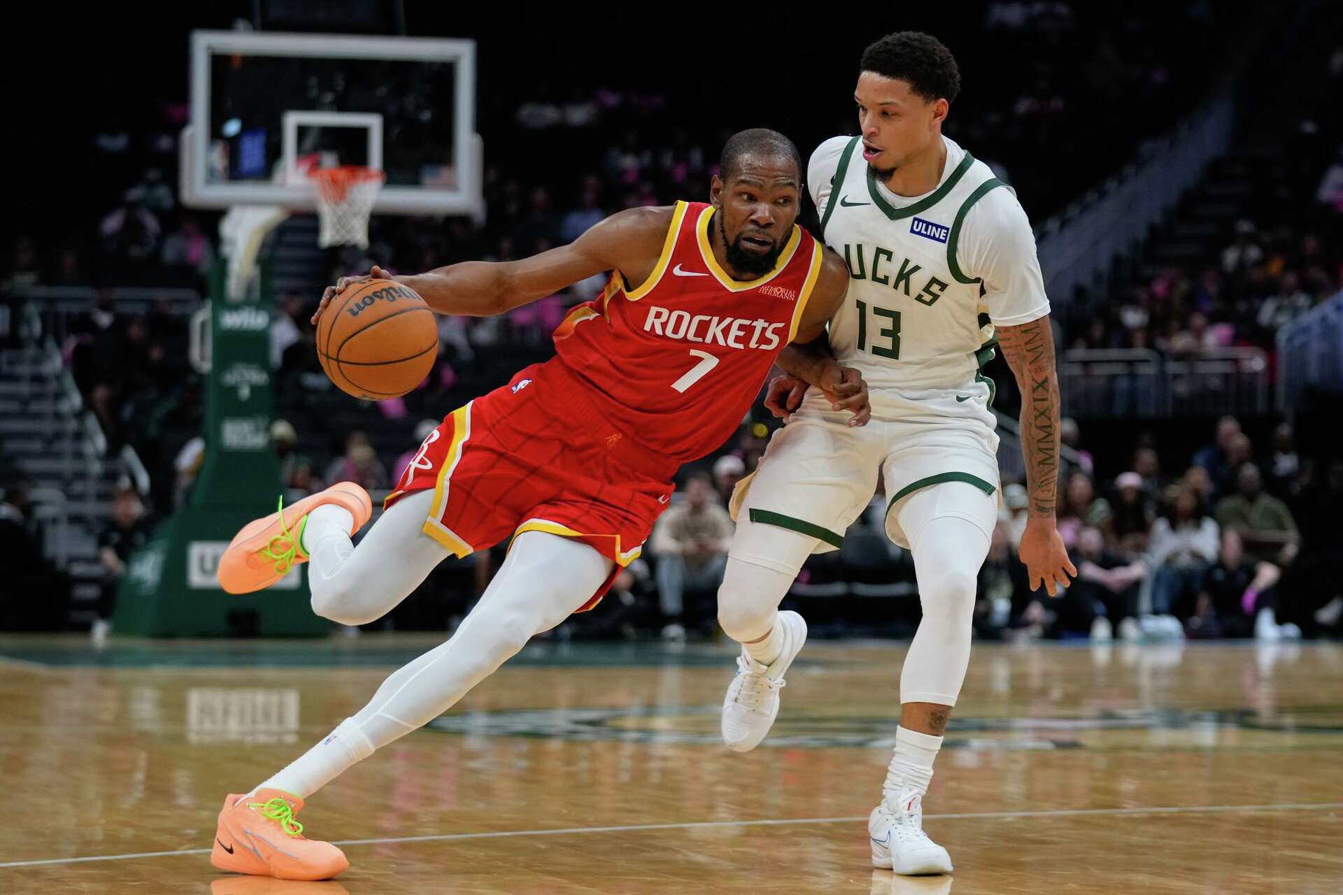 Houston Rockets forward Kevin Durant (7) handles the ball against Milwaukee Bucks guard Ryan Rollins (13) during the first half of an NBA basketball game Wednesday, Oct. 28, 2026, in Milwaukee.