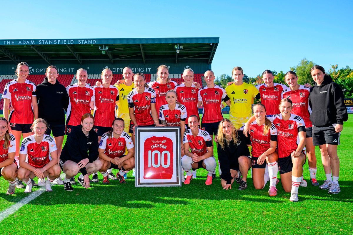 Bow Jackson of Exeter City Women  poses for a photo with her team mates as she marks her 100th appearance during the Women's National League - Premier Division match match between Exeter City Women  and AFC Bournemouth Women at St James Park, Exeter on 20 September 2026 (Photo: Tom Sandberg/PPAUK)