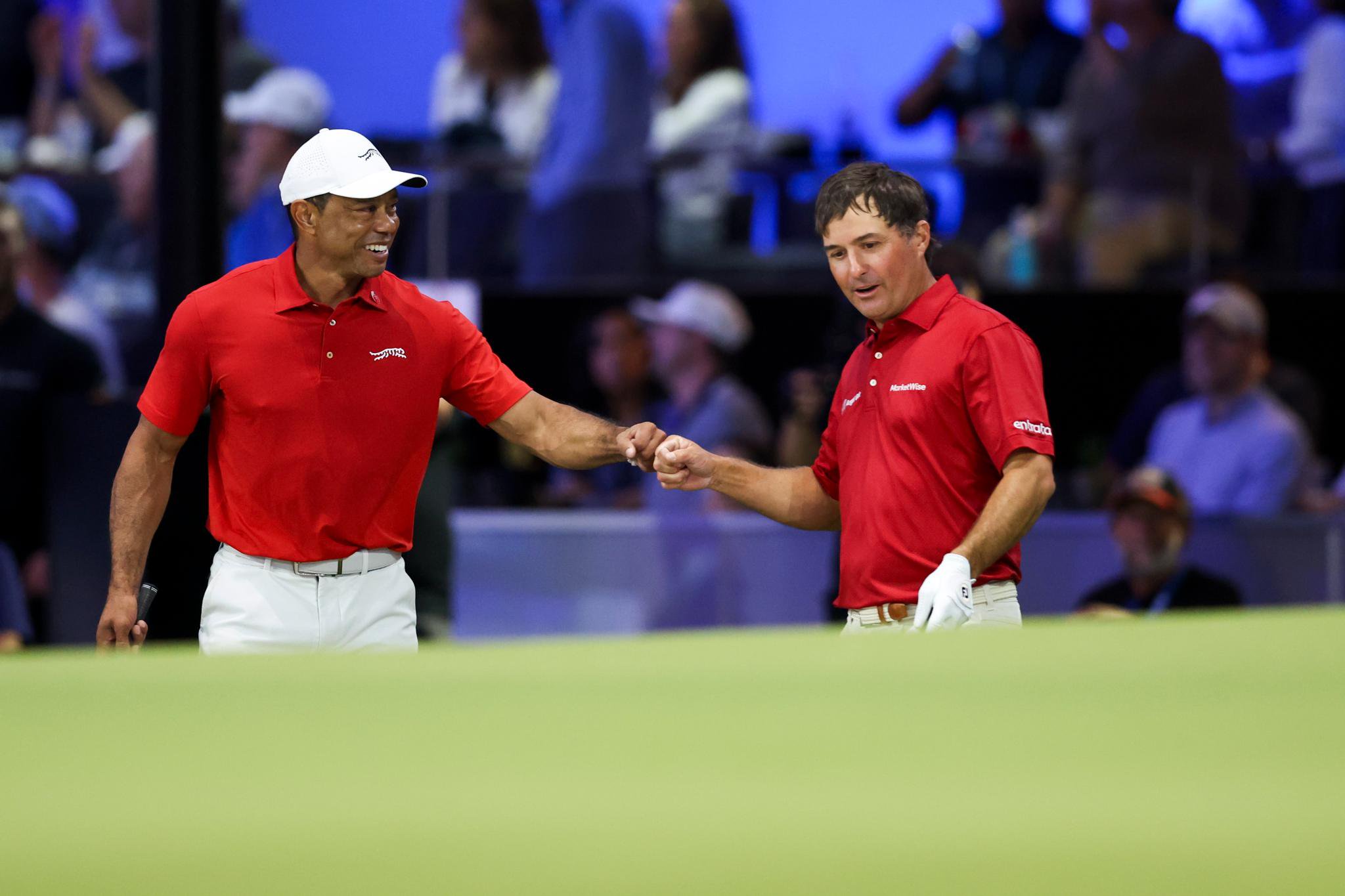 Tiger Woods of Jupiter Links Golf Club walks with teammate Kevin Kisner while playing the second hole during their TGL presented by SoFi match against New York Golf Club at SoFi Center on February 18, 2025 in Palm Beach Gardens, Florida.  