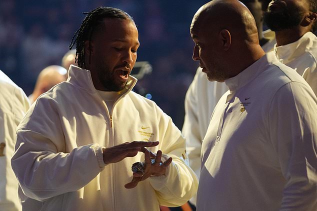 New York Knicks guard Jalen Brunson, left, shows his ring to his father Rick Brunson before an NBA basketball game between the New York Knicks and the Philadelphia 76ers Tuesday, Oct. 20, 2026, in New York. (AP Photo/Frank Franklin II)