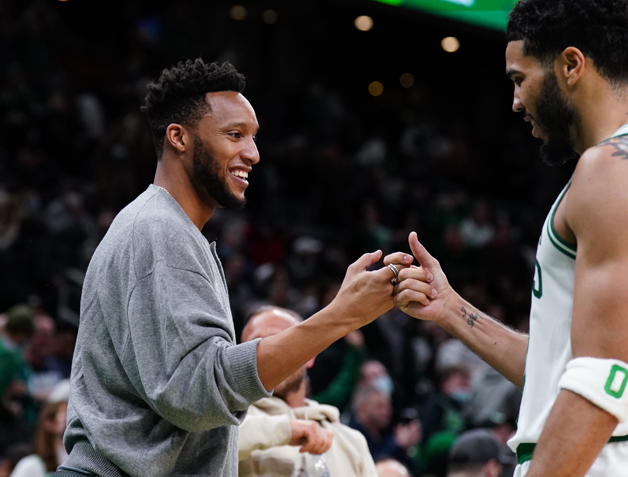 Mar 1, 2022; Boston, Massachusetts, USA; Former NBA player and former assistant coach for the Boston Celtics Evan Turner greets forward Jayson Tatum (0) during a break in the action against the Atlanta Hawks in the second half at TD Garden. Mandatory Credit: David Butler II-USA TODAY Sports