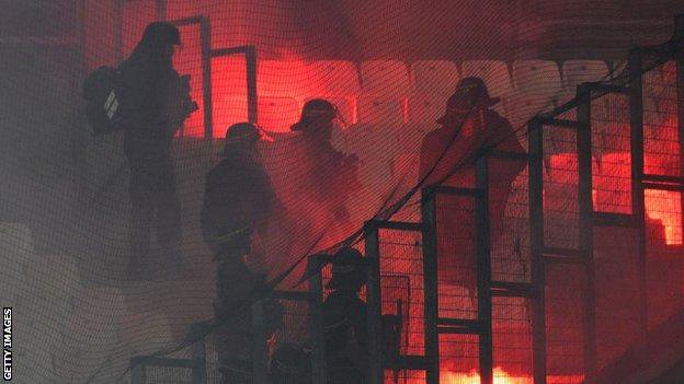 Police move into stands after flares are let off