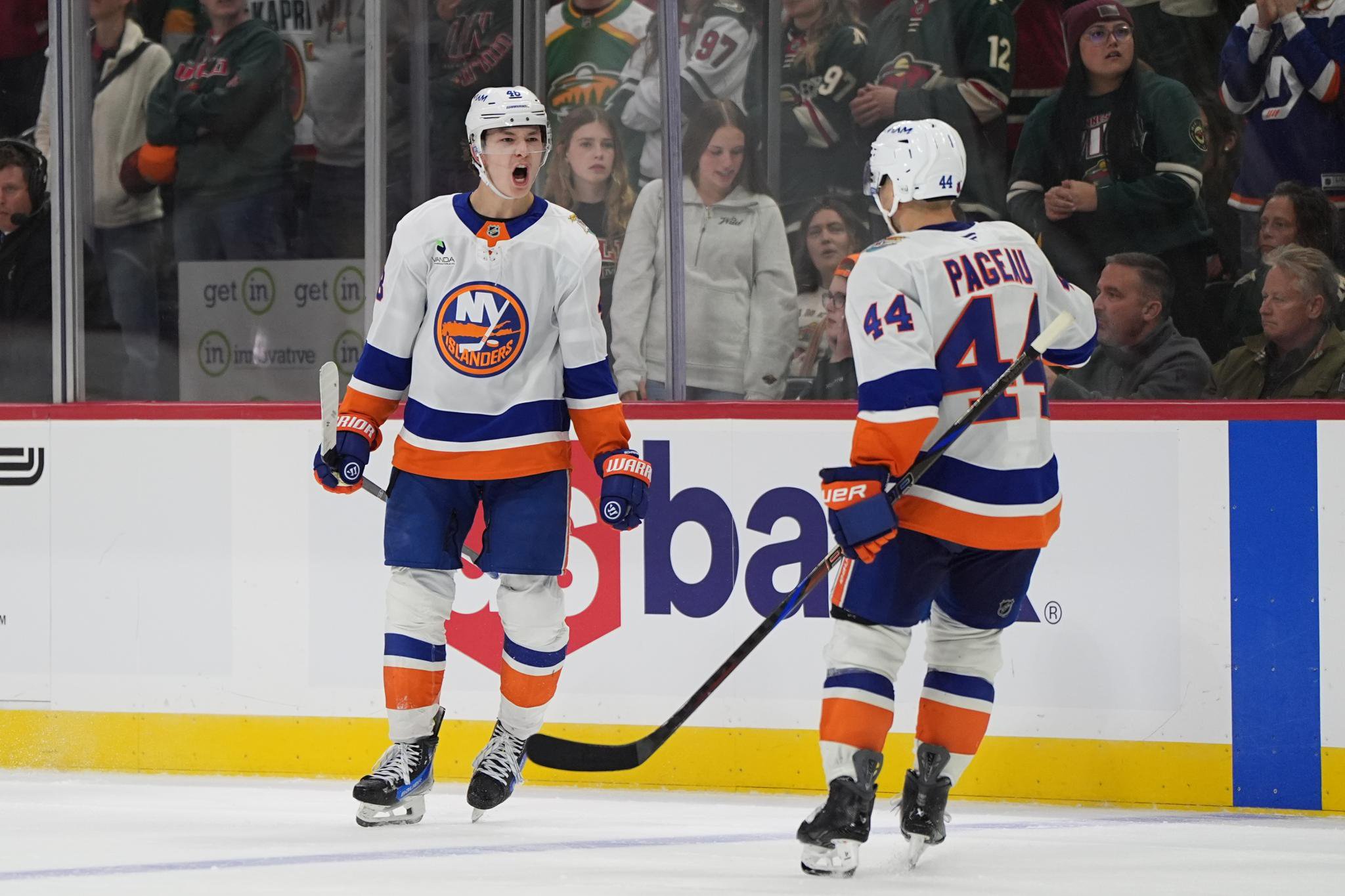 New York Islanders defenseman Matthew Schaefer celebrates with center Jean-Gabriel Pageau after scoring an overtime goal.