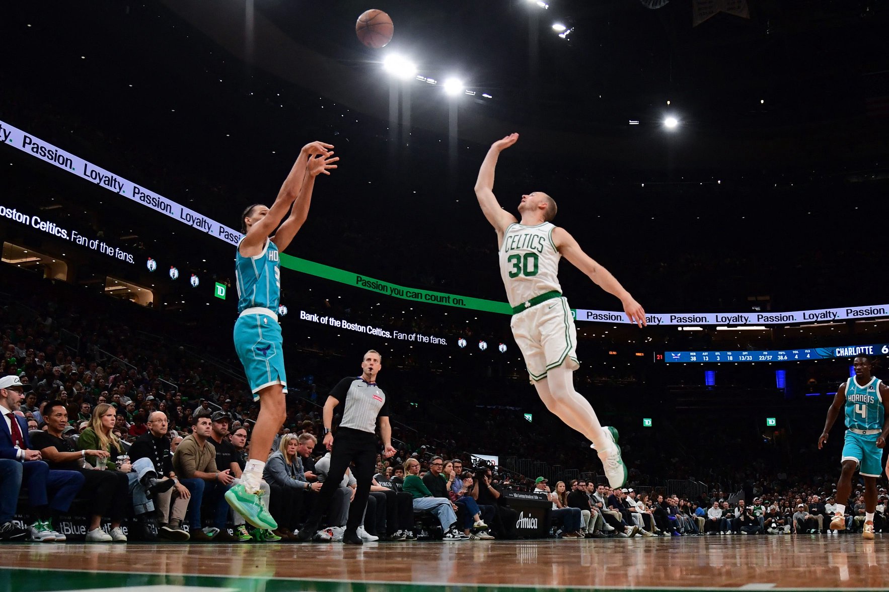 Oct 14, 2026; Boston, Massachusetts, USA;  Charlotte Hornets forward Tidjane Salaun (31) shoots the ball past Boston Celtics forward Sam Hauser (30) during the second half at TD Garden. Mandatory Credit: Bob DeChiara-Imagn Images