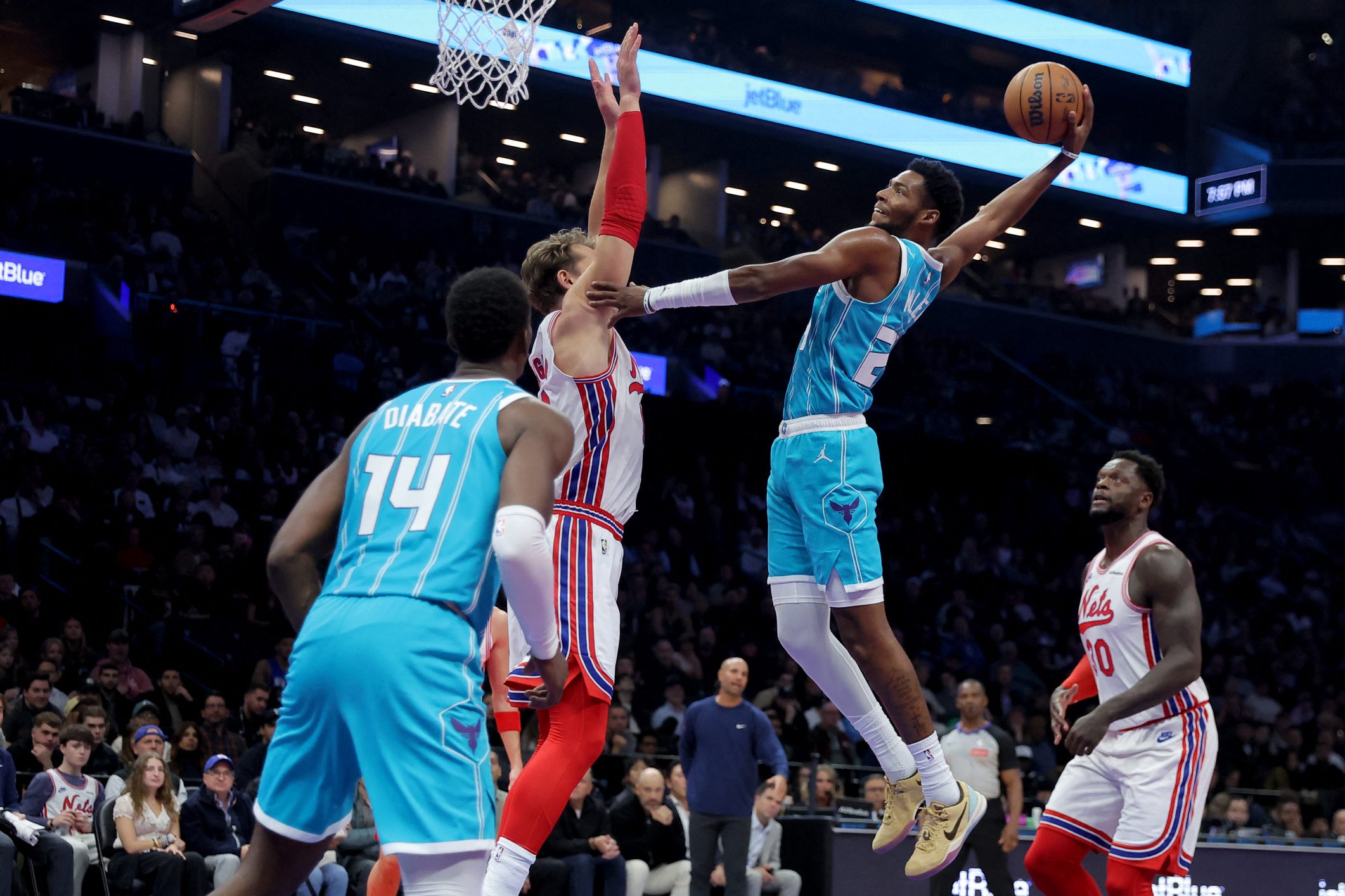 Oct 21, 2026; Brooklyn, New York, USA; Charlotte Hornets forward Brandon Miller (24) dunks against Brooklyn Nets center Moritz Wagner (13) during the first quarter at Barclays Center. Mandatory Credit: Brad Penner-Imagn Images