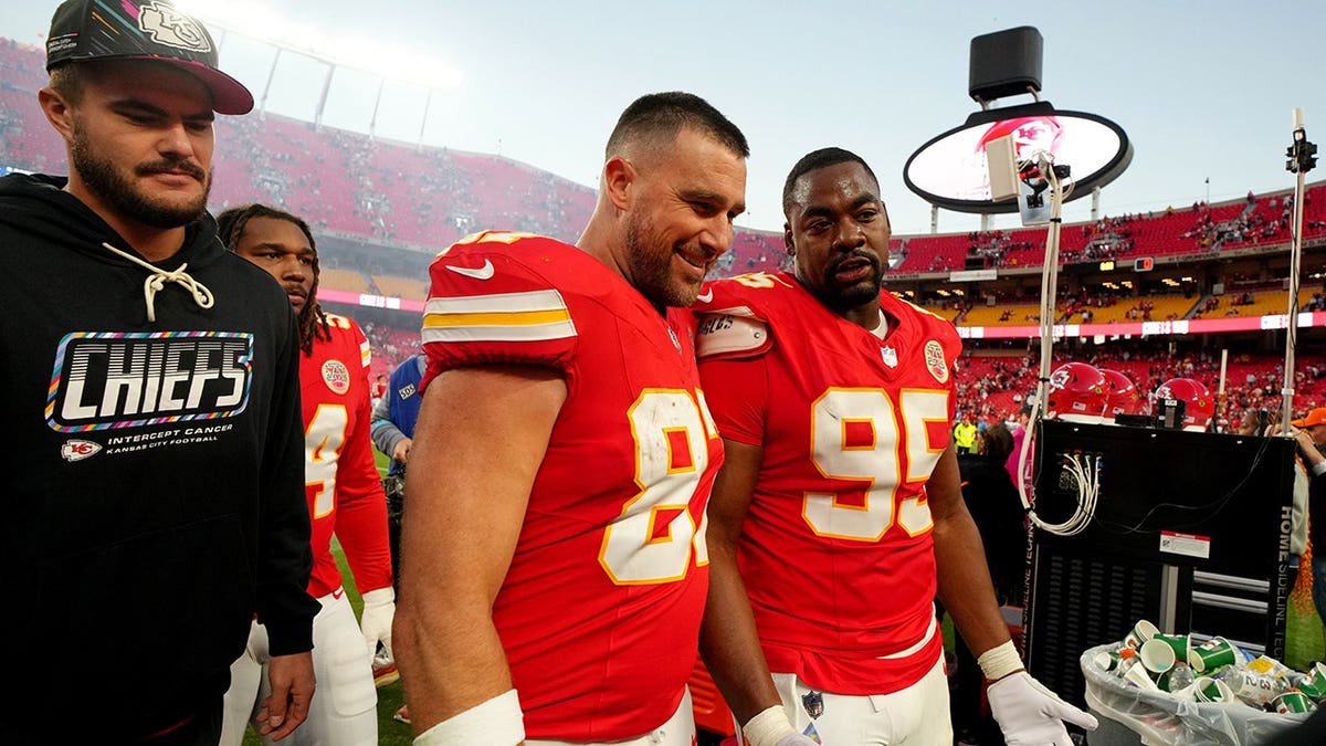 Travis Kelce and Chris Jones leave the field after an NFL game in Kansas City, Mo.