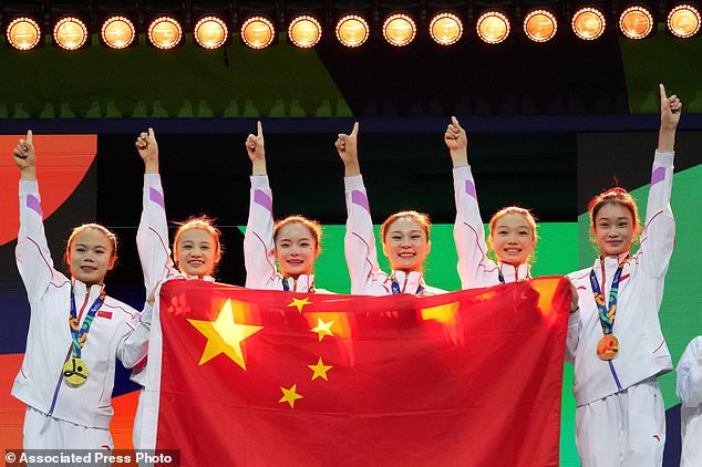 China athletes pose on the podium after winning the gold medal in the women's team final at the Artistic Gymnastics World Championships in Rotterdam, the Netherlands, Wednesday, Oct. 21, 2026. (AP Photo/Patrick Post)