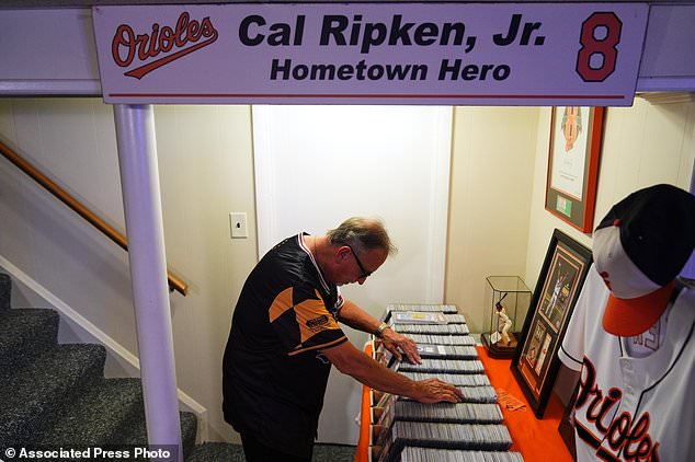 Baltimore Orioles fan Rick Taylor looks through his collection of tickets from almost every baseball game of Cal Ripken Jr.'s 2,632 game "Iron Man" streak, at his home in Reisterstown, Md., Tuesday, Oct. 13, 2026. (AP Photo/Stephanie Scarbrough)
