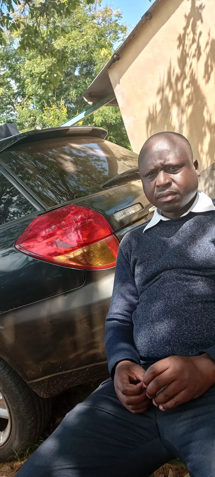 May be an image of 1 person, smiling, car and grass