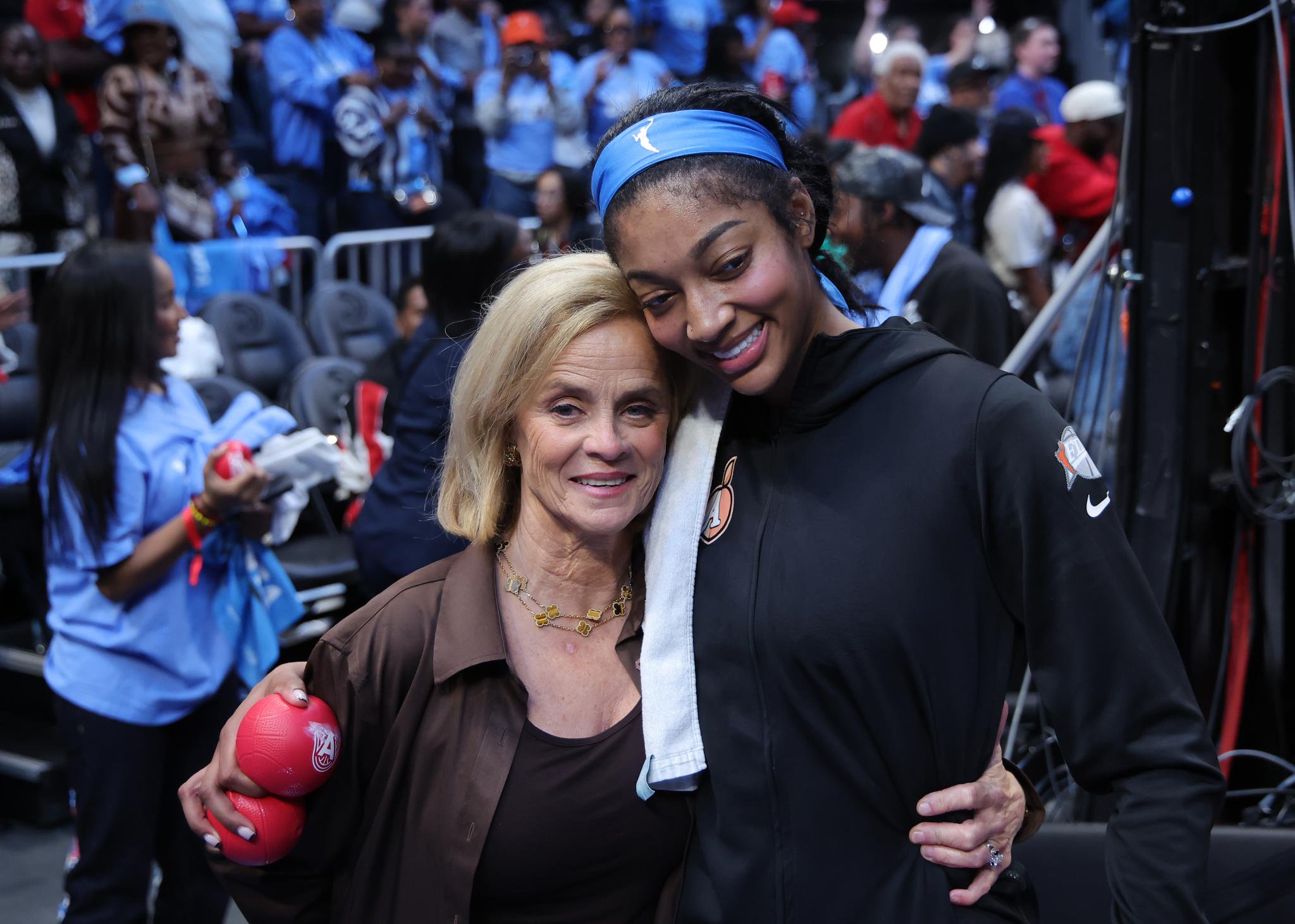 Kim Mulkey and Angel Reese pose together after a WNBA Finals game.