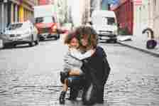 image of young woman and girl kneeling on a cobblestone road - Protecting Family Interests: When Legal Guidance Is Essential - Image source: https://unsplash.com/photos/photography-of-woman-carrying-baby-near-street-during-daytime-4-gFGb12hFA