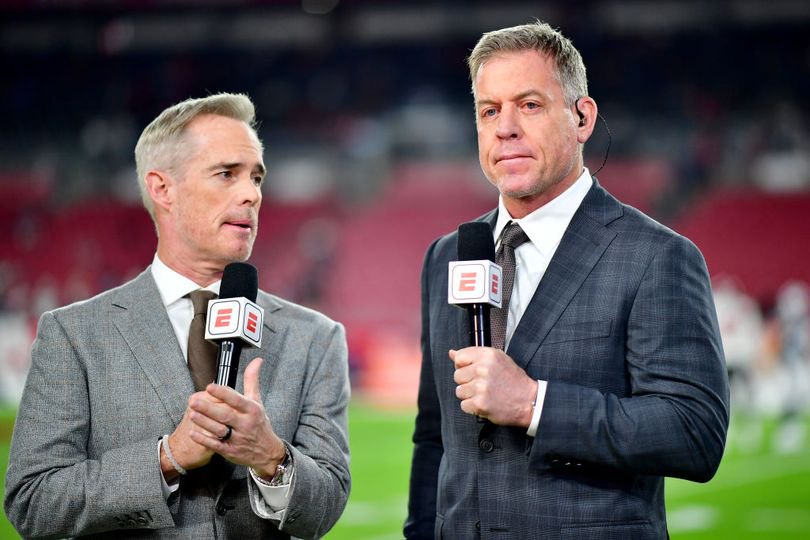 Joe Buck and Troy Aikman speak during a game