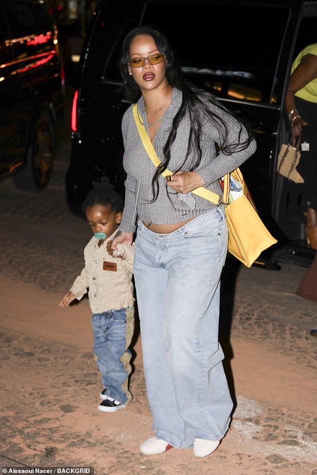 Let's go, baby: Rihanna's bump was on show as she headed into Cesar restaurant in Paris, France, with the youngest of her two sons Riot on Saturday