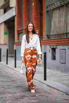 Woman wears white shirt with maxi skirt