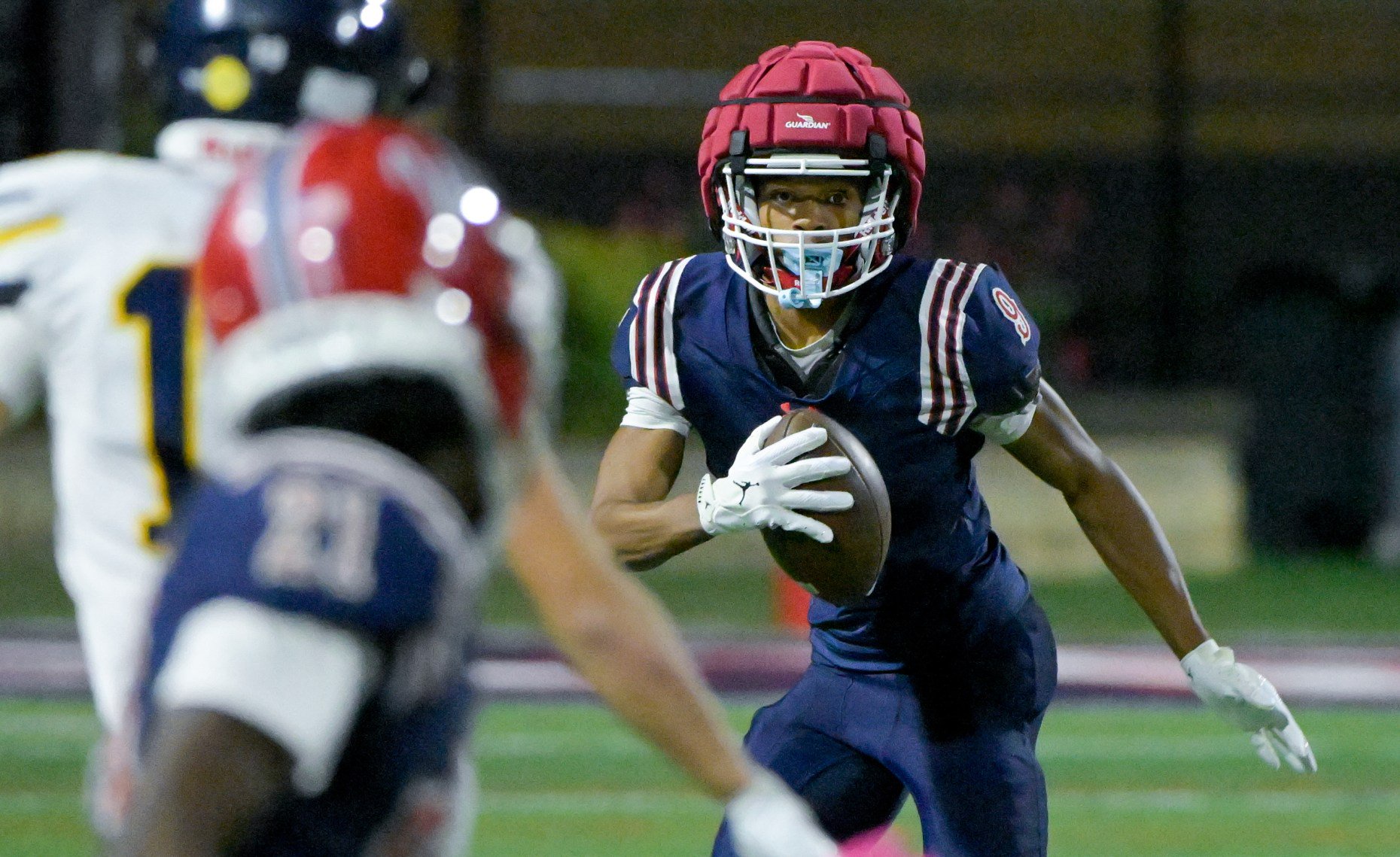West Aurora's Travis Brown Jr. (9) looks for an opening...