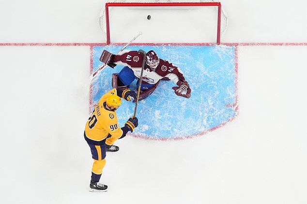 Nashville Predators center Ryan O'Reilly (90) celebrates a goal scored by left wing Filip Forsberg past Colorado Avalanche goaltender Scott Wedgewood (41) during the first period of an NHL hockey game Sunday, Oct. 25, 2026, in Nashville, Tenn. (AP Photo/George Walker IV)