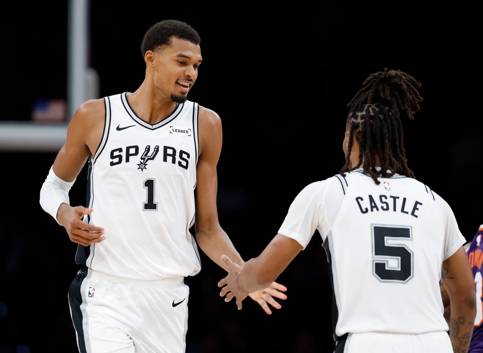 Spurs stars Victor Wembanyama and Stephon Castle during game against Suns