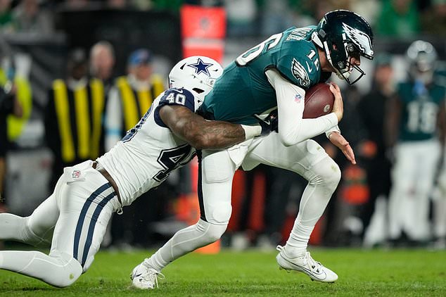 Philadelphia Eagles quarterback Tanner McKee (16) is tackled by Dallas Cowboys outside linebacker Von Miller (40) during the second half of an NFL football game in Philadelphia, Monday, Oct. 26, 2026. (AP Photo/Matt Slocum)